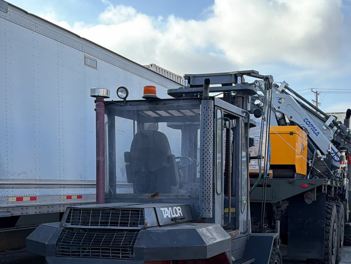 Taylor forklift in the yard beside the COPMA crane truck